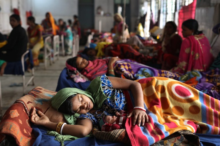 Cover photo for: Why are women still dying in childbirth in Nepal? A mother recovers with her newborn, who was delivered under the supervision of trained health professionals at Sri Krishna Medical College and Hospital, a public health facility. Institutional births are one of the government of India's key strategies to reduce infant and maternal mortality, and to improve the overall health of the mother and child. An average of 7,000 births take place at Sri Krishna Medical College and Hospital each year.
