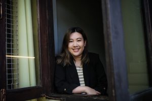 Photo of May at a window.
