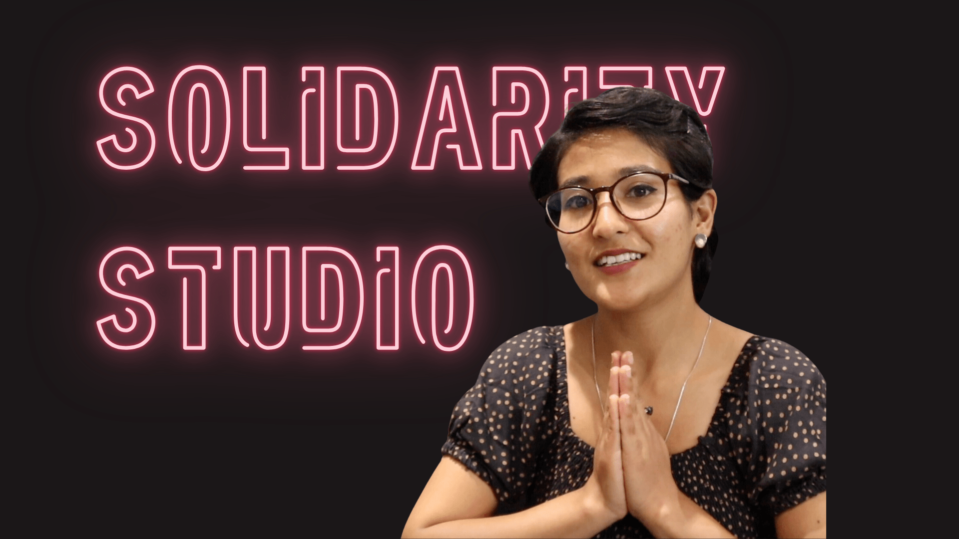 Pink neon text on Black background with the words SOLIDARITY STUDIO and the profile of Neha Gurung, wearing a black dotted blouse and glasses.