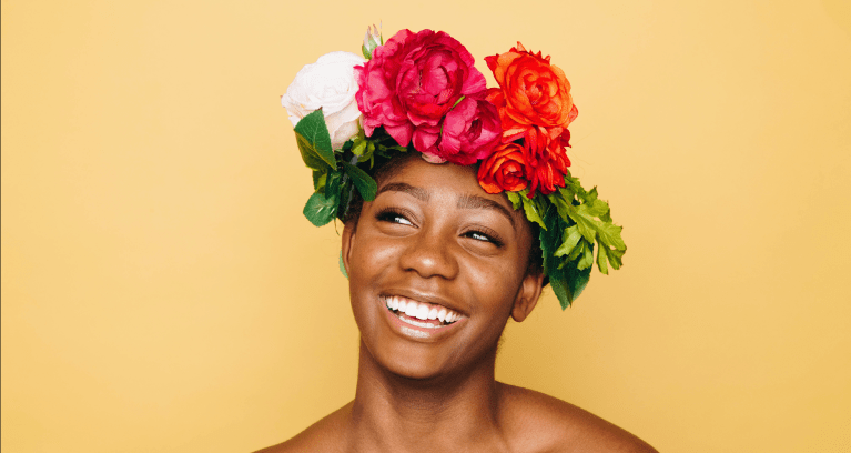 Self Care for Black Women. Black woman smiling with floral crown