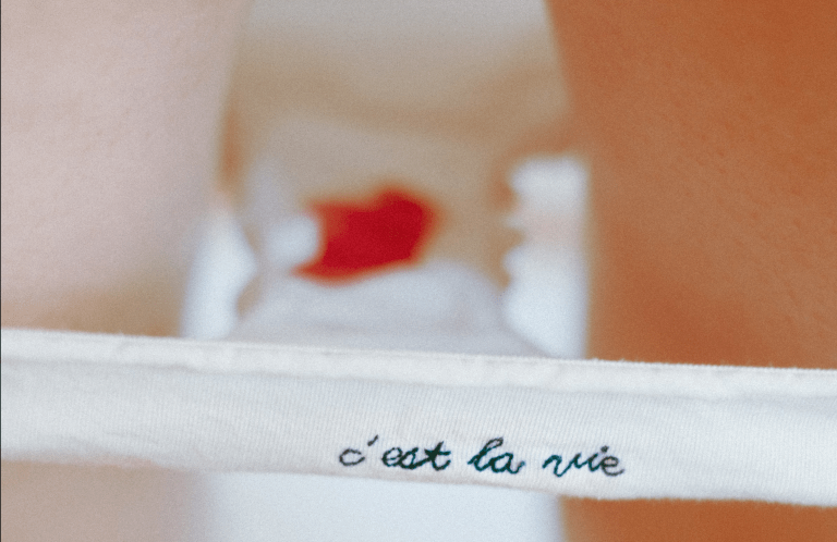 Photo of period blood in underwear with the words c'est la vie. Cover photo for gender-inclusive language around periods post.