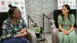 Felogene Anumo and Spogmay Ahmed sitting in the Girls' Globe Solidarity Studio. Each in a sofa chair with podcast microphones in front of them. Spogmay explains Feminist Foreign Policy.